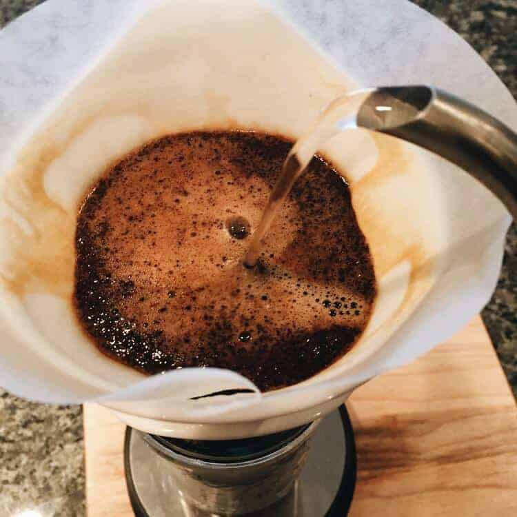 Controlled water pouring over ground coffee