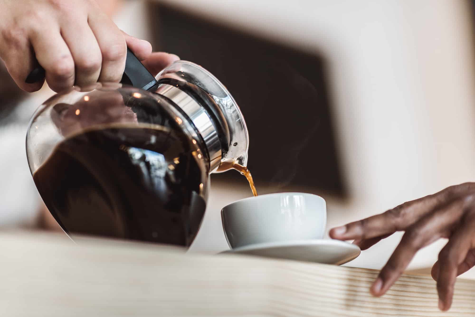 serving coffee from a drip coffee maker carafe