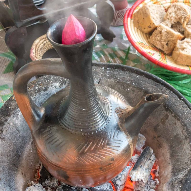 Brewing traditional Ethiopian Coffee with Jebena using charcoal