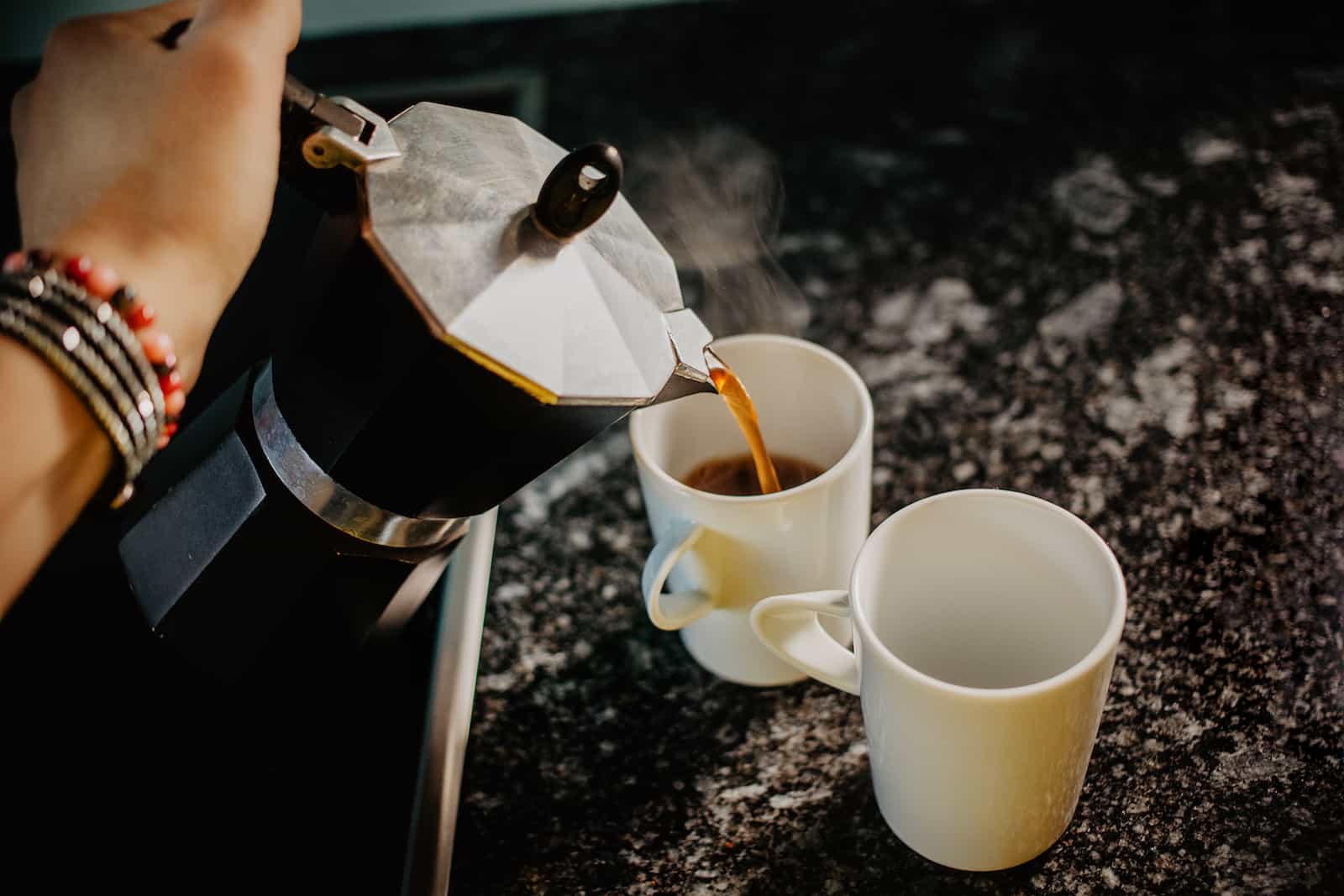 Preparing fresh coffee in moka pot