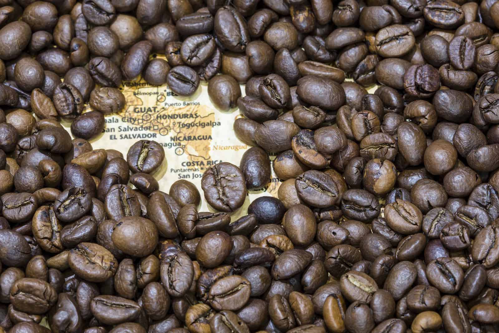 Map of Central America under a background of coffee beans