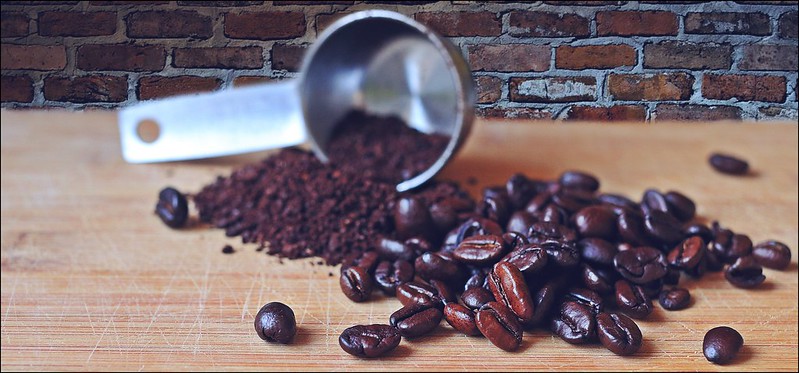 ground coffee beans and whole beans on table