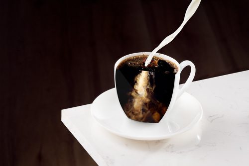 pouring milk into coffee