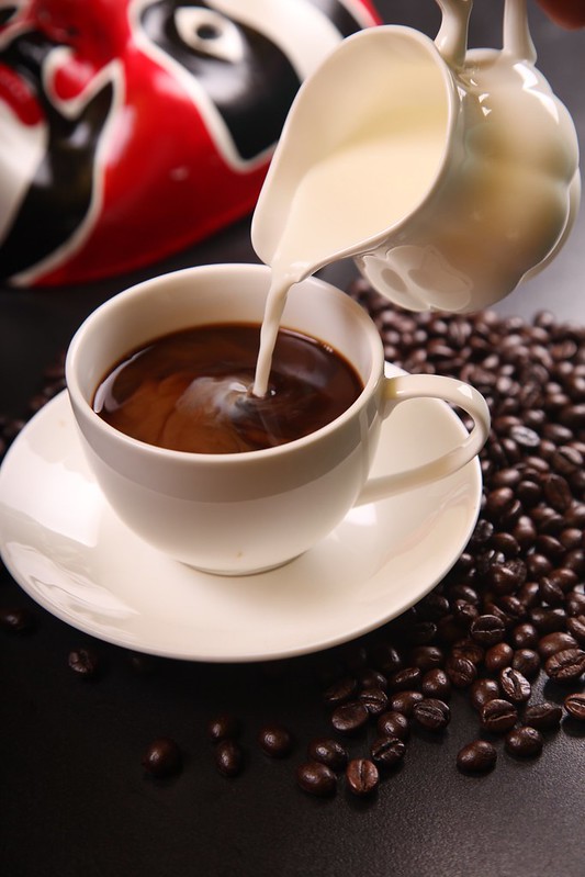Feature image pouring milk in coffee